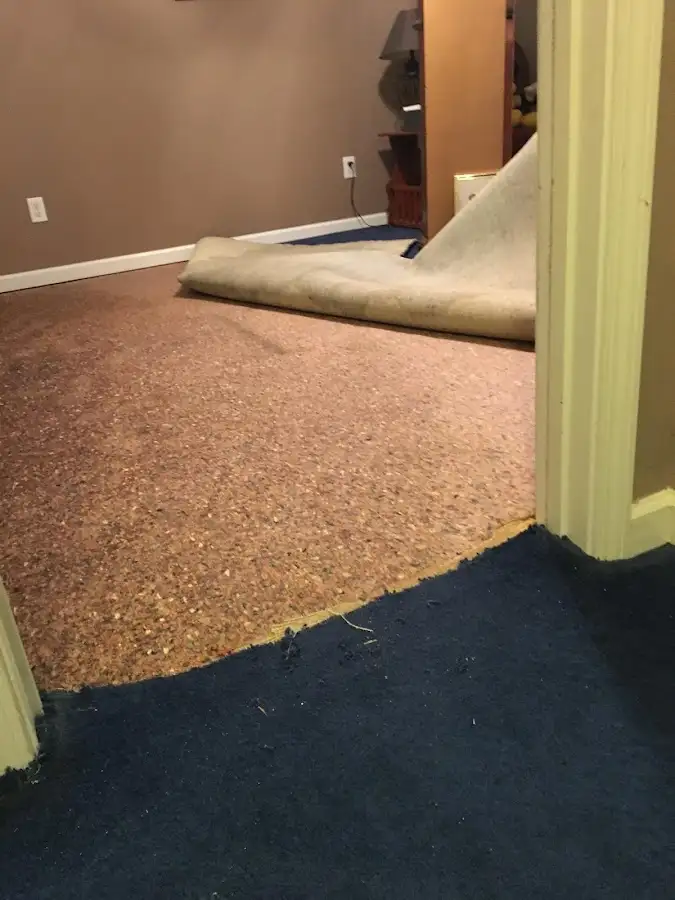 Carpet pad removal revealing water damage during Drying & Dehumidification in Lindenhurst
