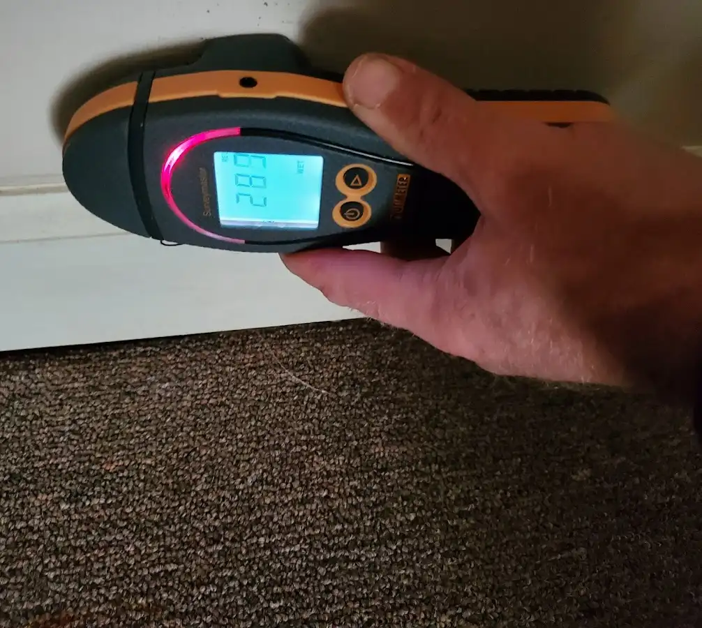 Moisture detection at baseboard during Storm Damage Restoration in Lindenhurst
